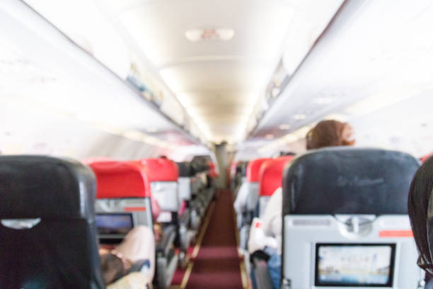 istock Blur commercial aircraft cabin with passengers as background 1028540296