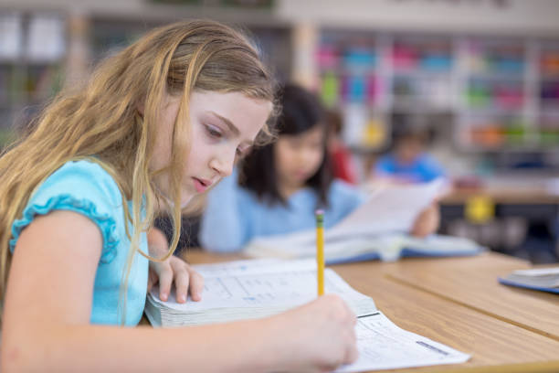 istock 4th grade girls studying in the classroom 1028549694