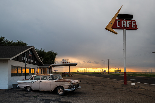 Route 66, August 1, 2018. Old motel and American car by the Half Point on Rout66, between Chicago and Los Angeles