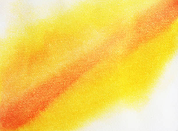 istock Yellow and orange color stains flow on white surface 1028555390
