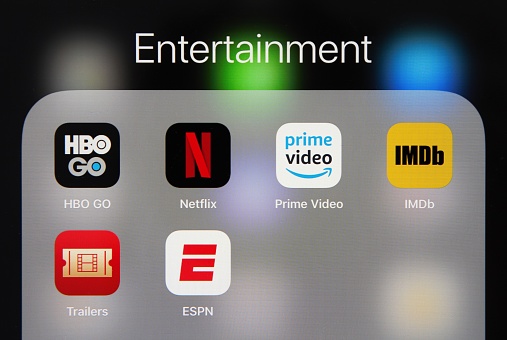 Popular video apps, including Netflix, HBO, ESPN, IMDb and Amazon Prime Video, are grouped on an Apple iPad tablet screen under the category heading of Entertainment.