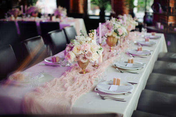 istock wedding table setting with flower vases and seating for guests 1028580362