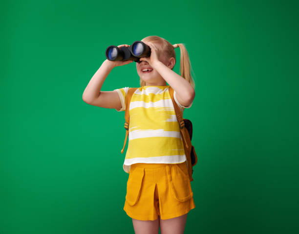 istock smiling pupil looking into distance through binoculars 1028596622