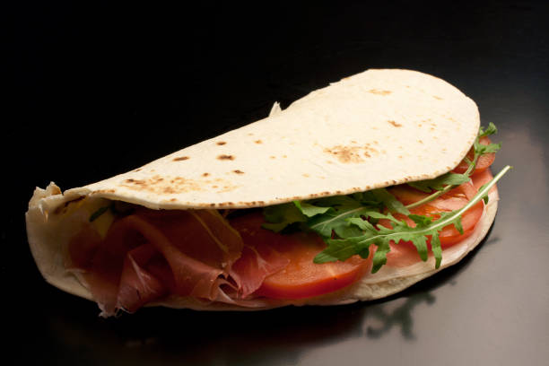 istock Isolated piadina on black background 1028599858