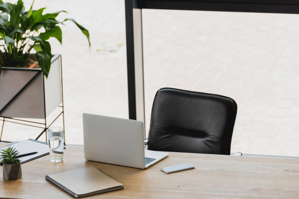 istock laptop and smartphone on wooden table in modern office 1028602334