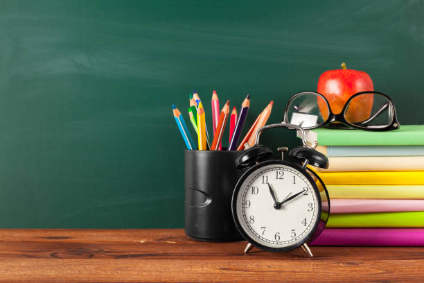 istock back to school - apple and books with pencils and blackboard 1028603514