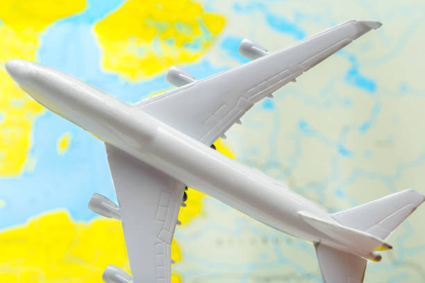 istock miniature of a passenger aircraft flying on a map 1028606320