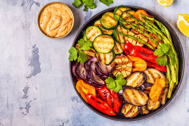 istock Grilled vegetables on a plate with sauce 1028606898