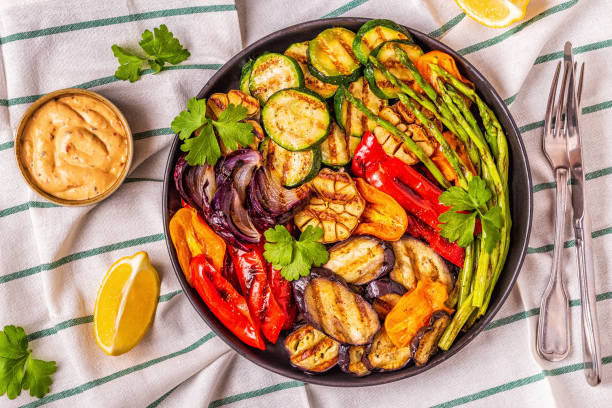istock Grilled vegetables on a plate with sauce 1028606970