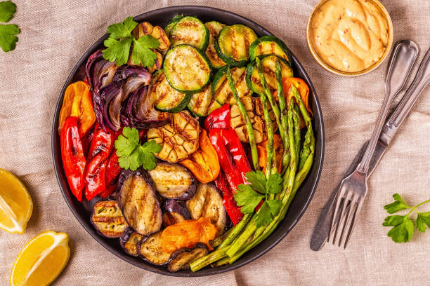 istock Grilled vegetables on a plate with sauce 1028606998