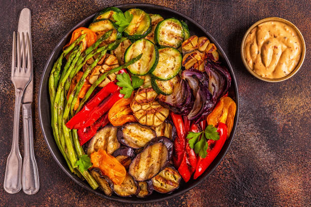 istock Grilled vegetables on a plate with sauce 1028610062