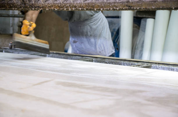 istock Worker is polishing marble  in marble factory 1028613944