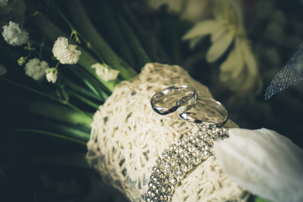 istock Platinum Wedding Rings on Diamond studded bouquet 1028640284