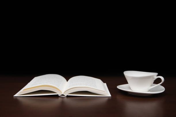 istock a book open on the desk with a cup of coffee. 1028643128