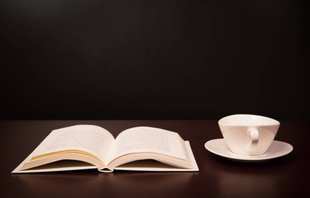 istock a book open on the desk with a cup of coffee. 1028643144