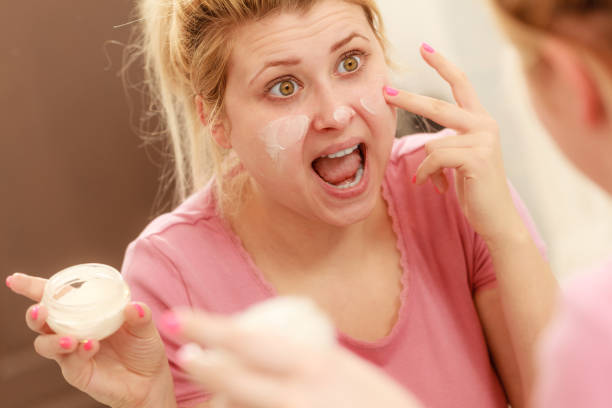 istock Woman applying face cream with her finger 1028643250