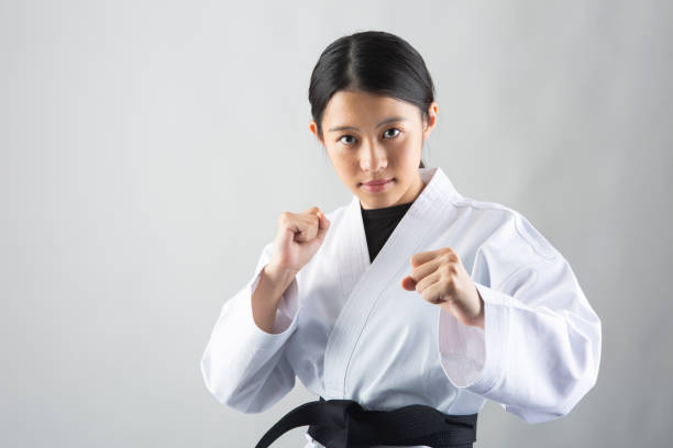 istock Woman wearing Karate uniform taking a fighting stance 1028643944