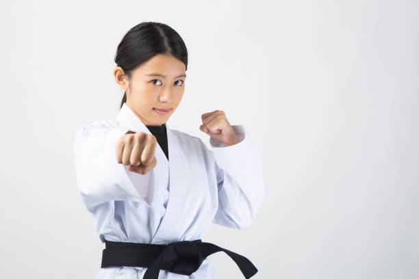 istock Woman wearing Karate uniform punching 1028645014