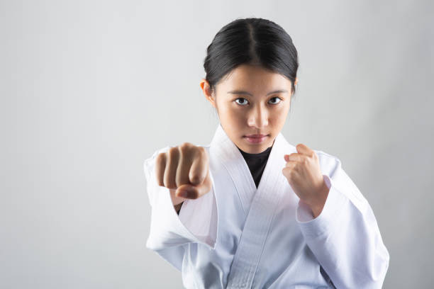 istock Woman wearing Karate uniform punching 1028645040