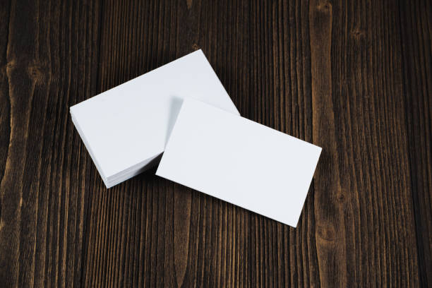 istock Blank business cards on wooden working table with copy space for add text ID. and logo, business company concept. 1028651776