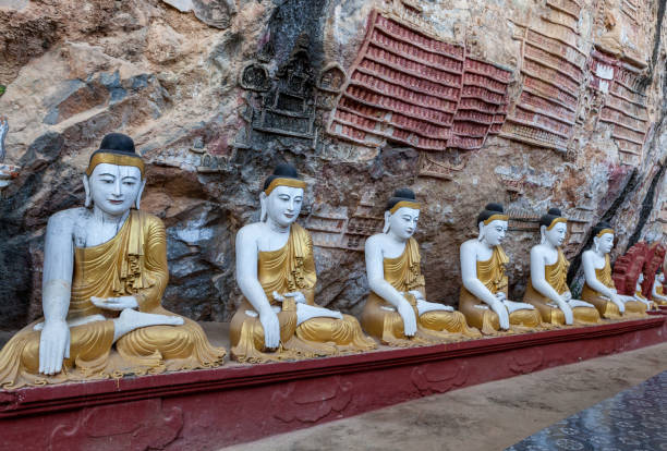 istock Old temple with buddha statues in Kaw Goon cave. 1028658734