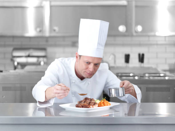 istock Male chef preparing steak plate 1028665196