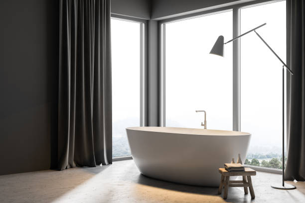 istock White bathtub in gray curtains bathroom side view 1028673264