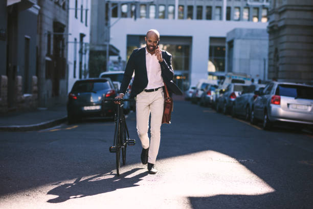 istock Young businessman going to work with his bicycle 1028675812