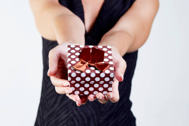 A gift box from the young woman on white background