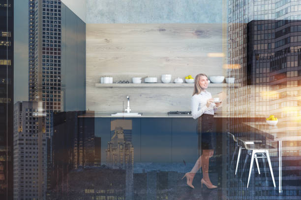 istock Black and wooden kitchen interior, woman 1028676592