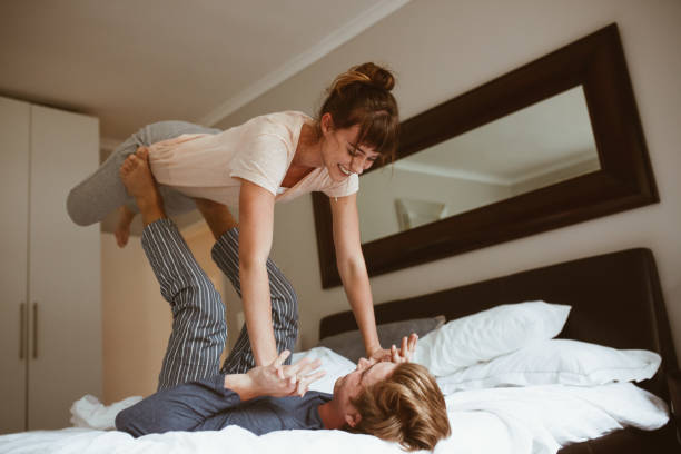 istock Couple having fun playing on bed at home 1028676896