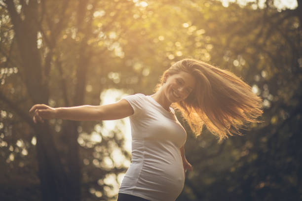 I enjoy every moment of pregnancy. Pregnant woman in nature. Close up, Copy space.