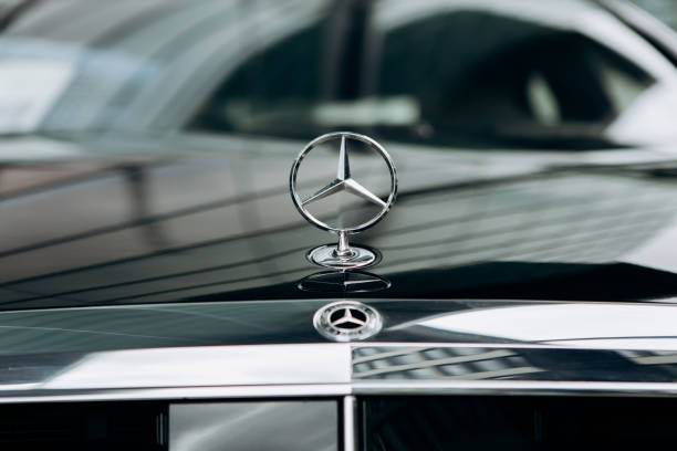 A close-up of the Mercedes sign and the front of the new luxury black Mercedes-Benz car stock photo