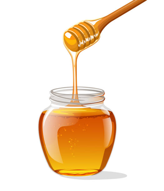 istock Glass jar of honey with wooden spoon 1028682958