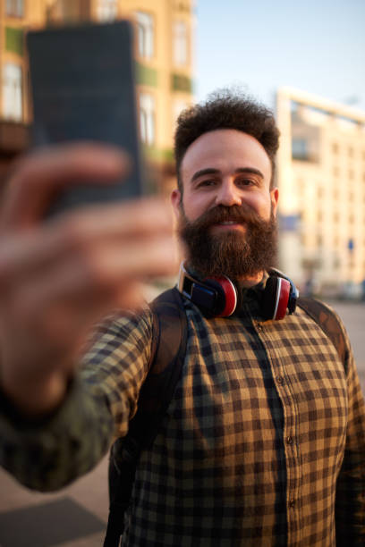 istock Male hipster person taking a selfie image 1028687076