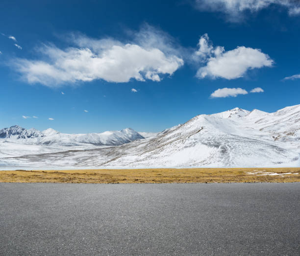 istock empty asphalt road and snow mountain 1028687574