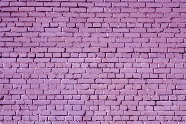 istock Violet color old grungy brick wall surface. 1028691154