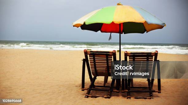 Tropical Sandy Beach With Colorful Umbrella And Beach Deck Chair Goa Stock Photo - Download Image Now