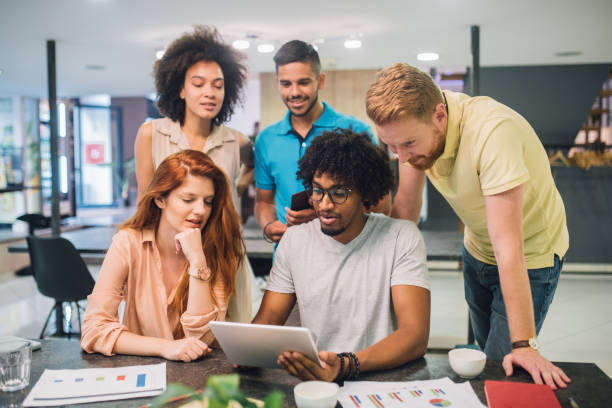 istock A group of casual young people talking in a an office 1028699802