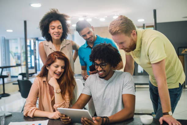 istock A group of smiling young people talking in a an office 1028699854