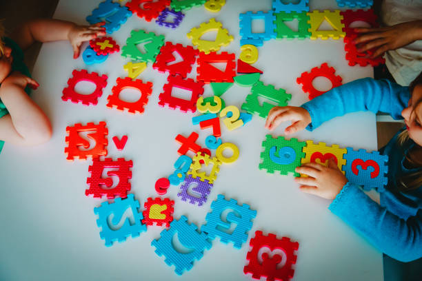 kids playing with number and shapes puzzle, learning concept