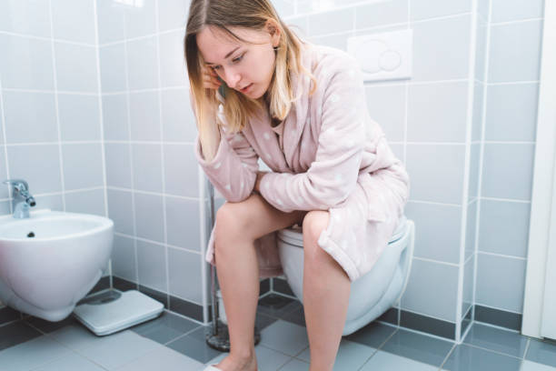 istock Sitting on a toilet, sad, crying 1028702634