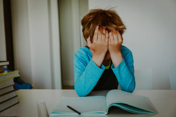 istock little boy cry tired of doing homework, overload 1028702888