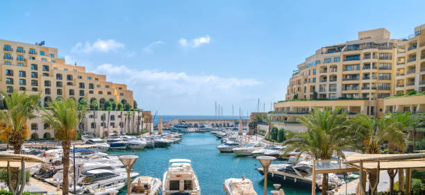 Luxury Portomaso Marina in St Julians, Malta 15 July 2018 - St Julians, Malta. Elegant and picturesque Portomaso Marina, well planned modern luxury apartments full of expensive yachts. st julians bay stock pictures, royalty-free photos & images