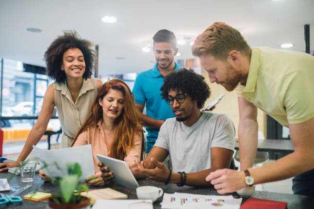 istock Happy young business people working on a presentation 1028706078