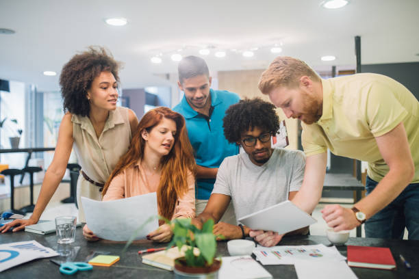 istock Young people looking at a business presentation 1028706124