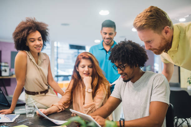 istock Group of handsome young people working in an office 1028706204