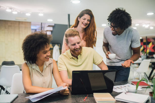 istock Laughing young business people in a meeting 1028706364