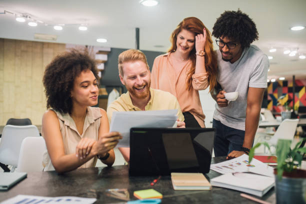 istock Casual young business people looking at a document 1028706510