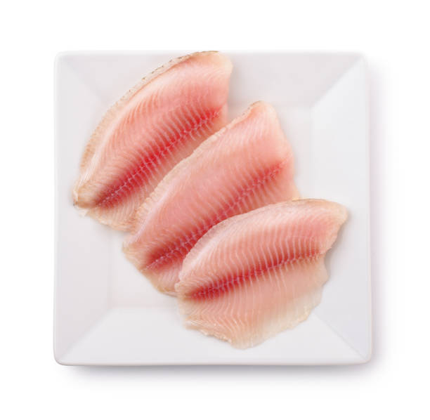 生の魚の切り身とプレートのトップ ビュー - prepared fish tilapia fillet seafood ストックフォトと画像